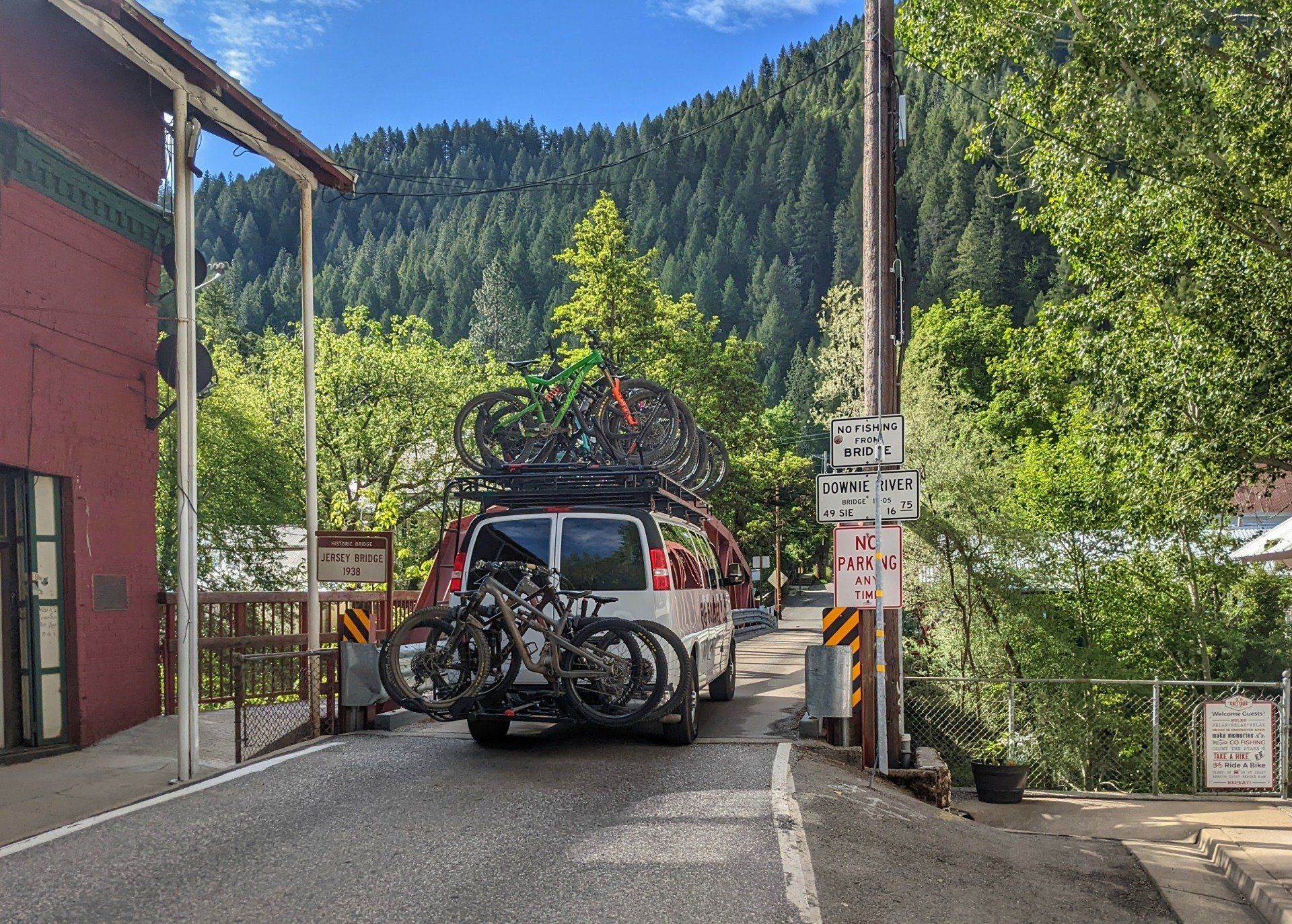 A van with bikes on top of it is parked on the side of the road