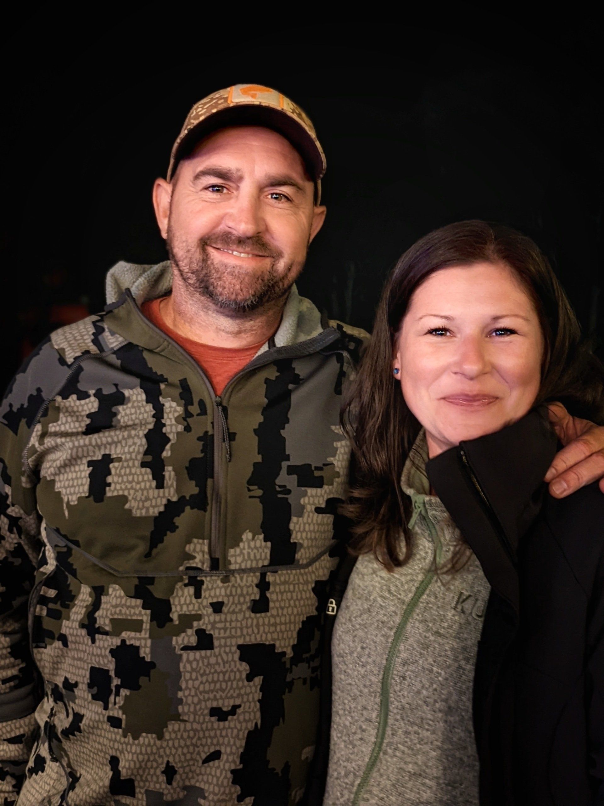 A man and a woman are posing for a picture together.