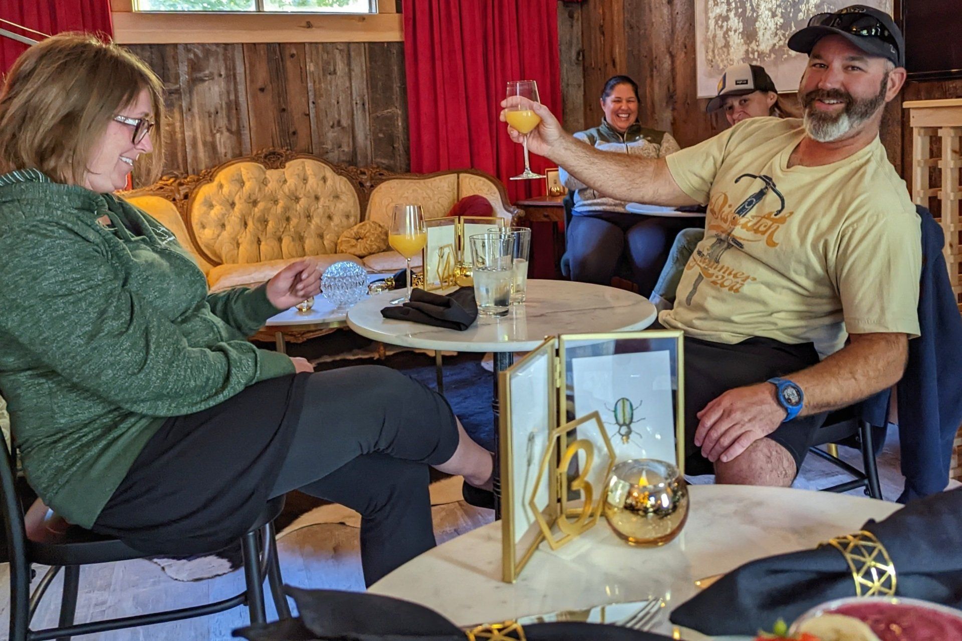 A man and a woman are sitting at a table in a restaurant.