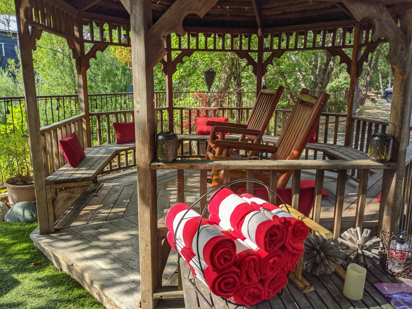 A gazebo with a bunch of red and white towels on it