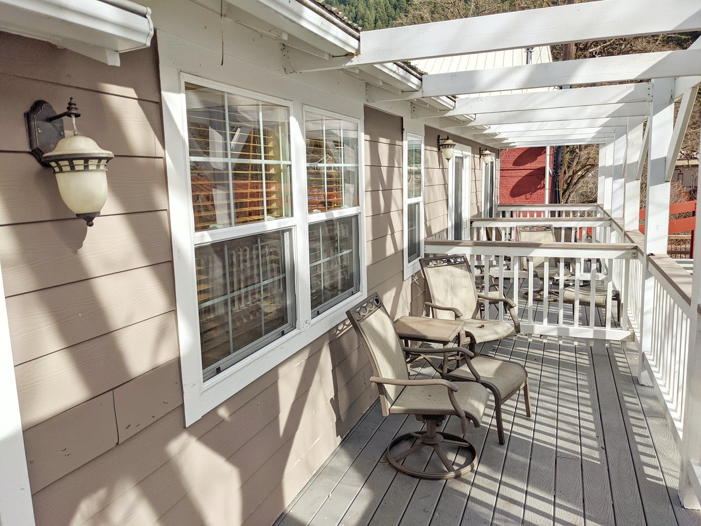 A porch with a table and chairs on it