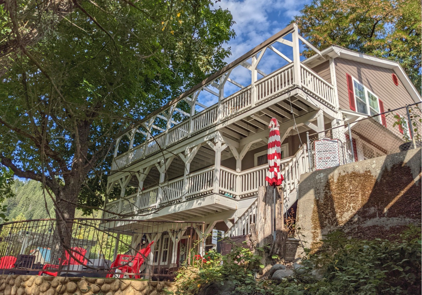 A large house with a lot of balconies is sitting on top of a hill.