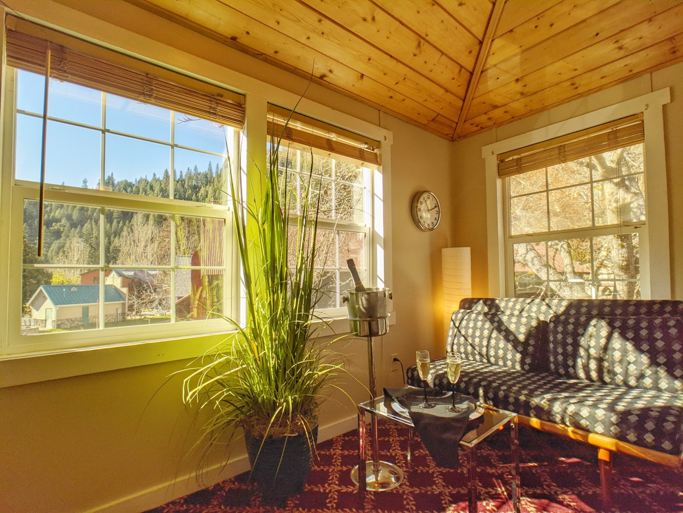 A living room with a couch , table , and window.