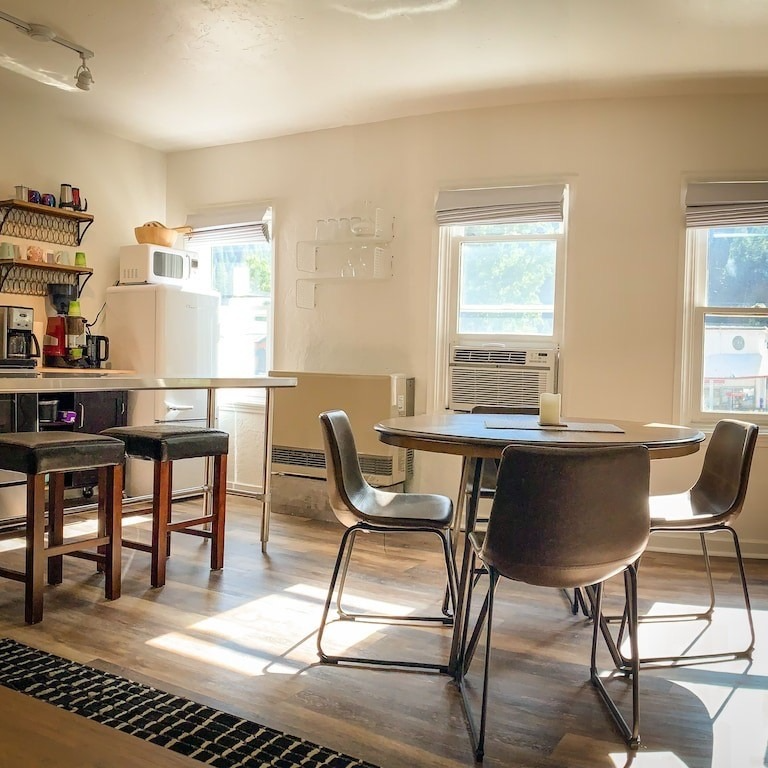 A kitchen with a table and chairs and a refrigerator