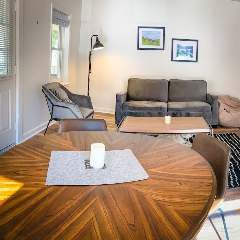 A living room with a couch and a table with a candle on it