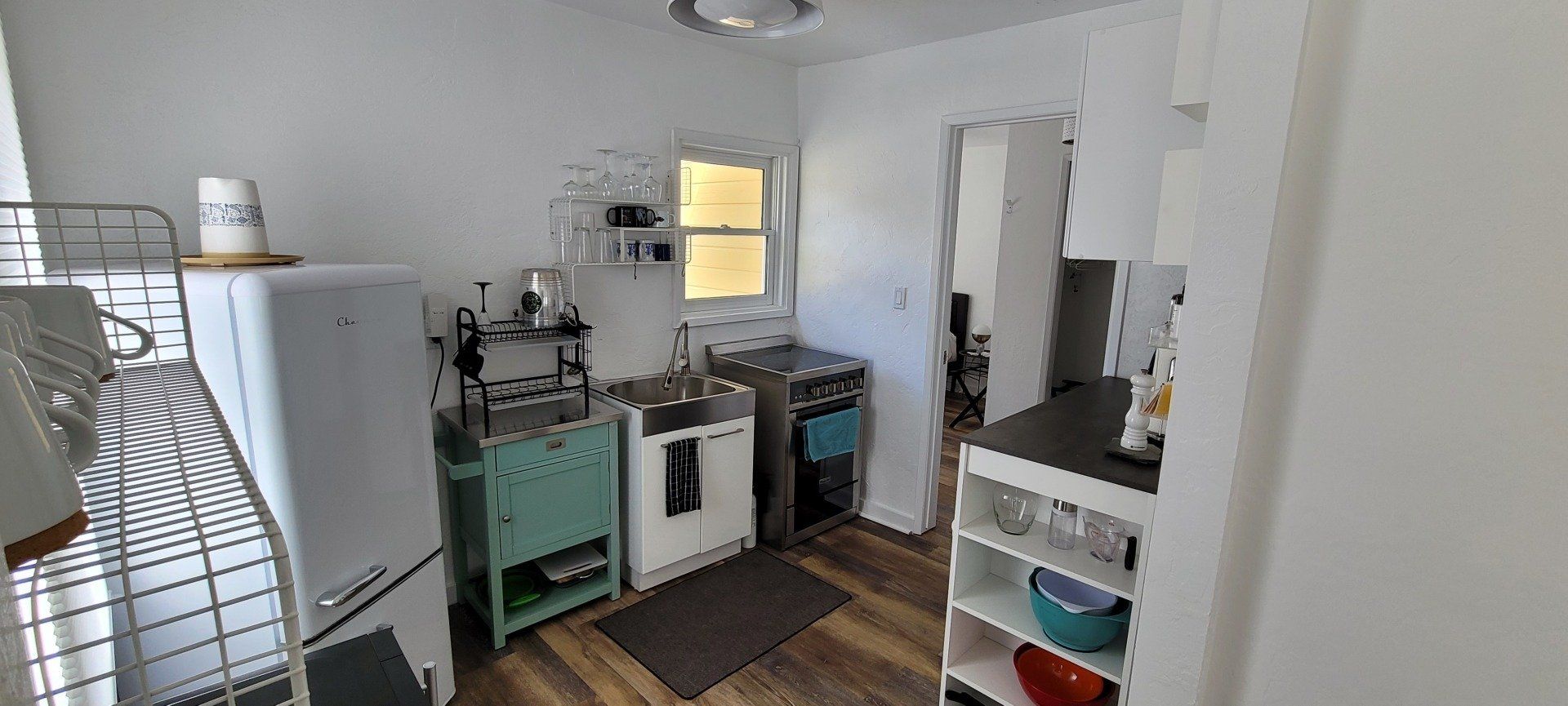 A kitchen with a refrigerator , sink , and microwave.