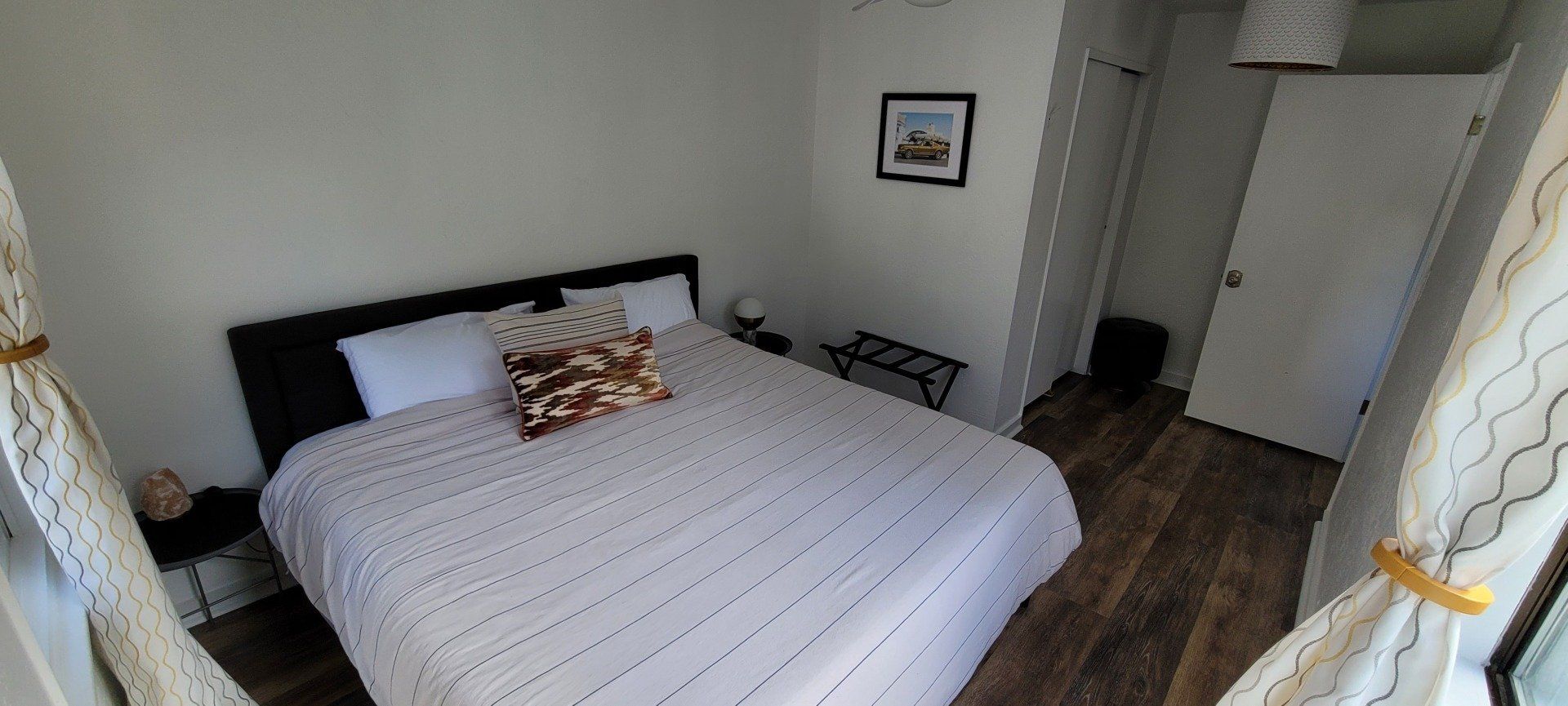 A bedroom with a large bed and a window.