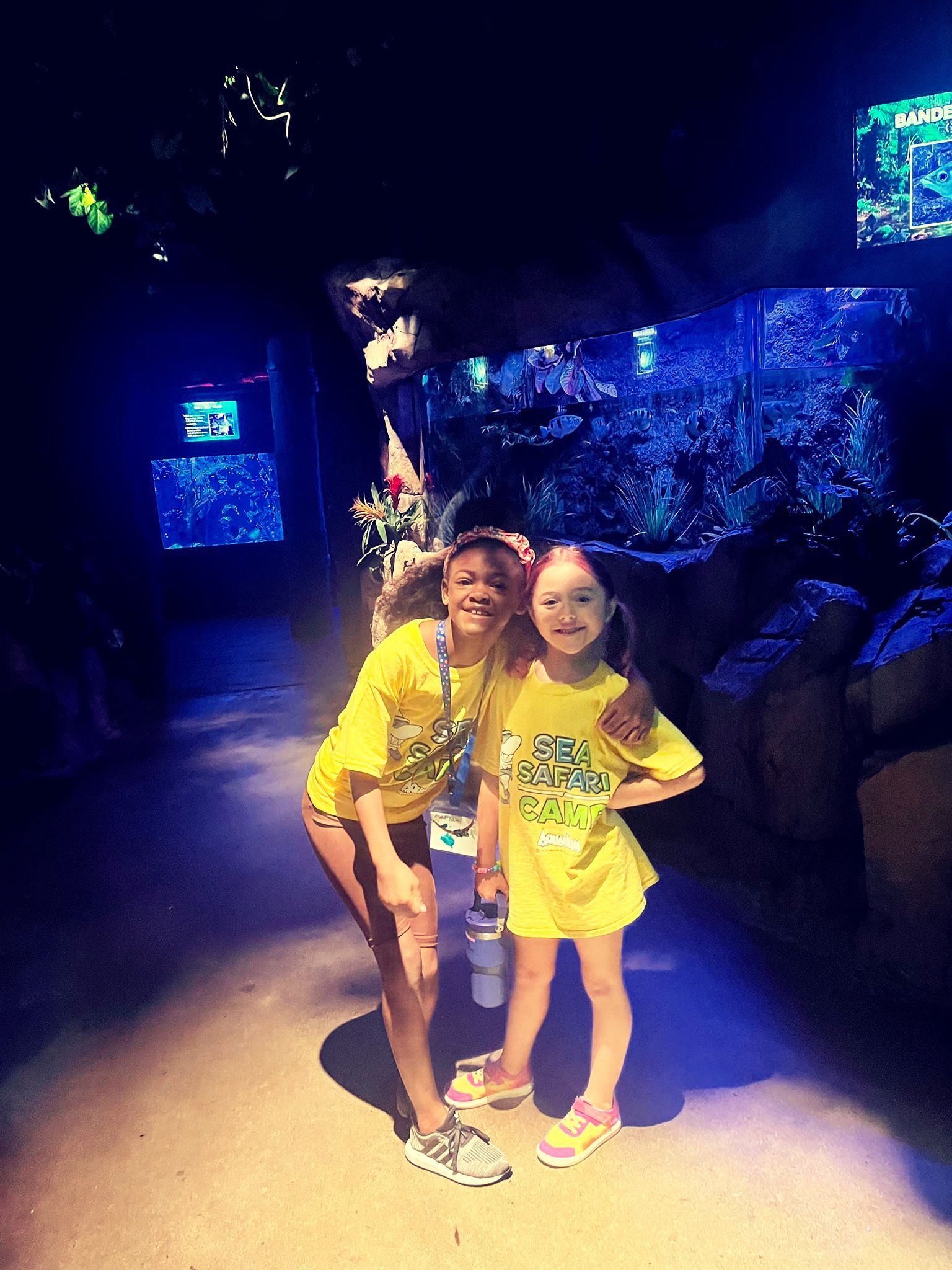 Two girls wearing yellow shirts 