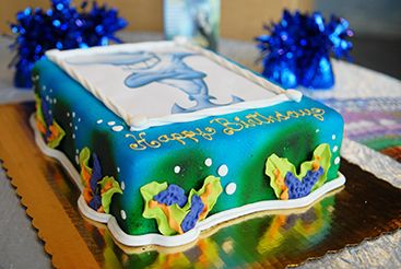 A birthday cake with a picture of a dolphin on it