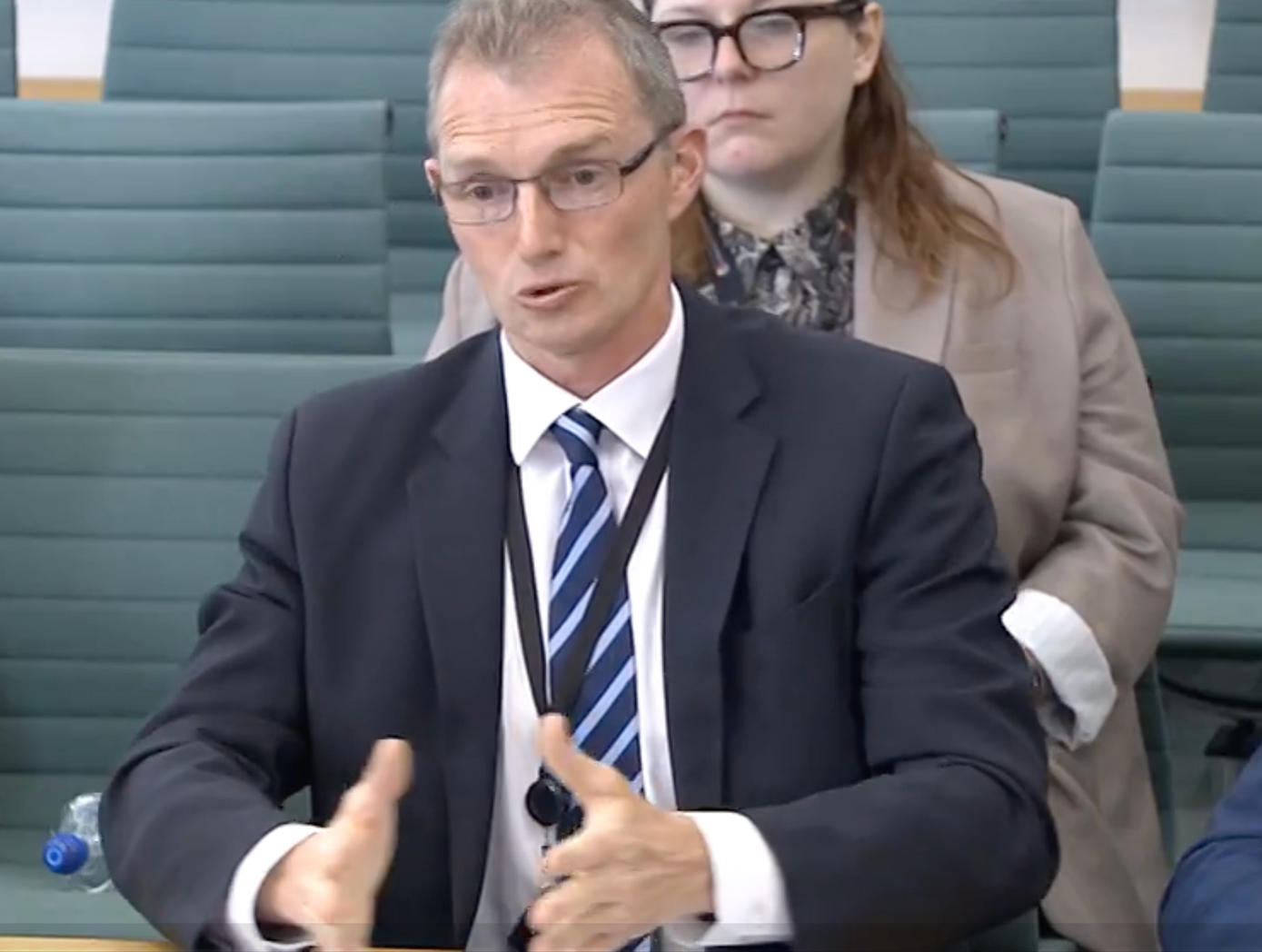 David TC Davies - former Secretary of State for Wales in a suit and tie is sitting at a table