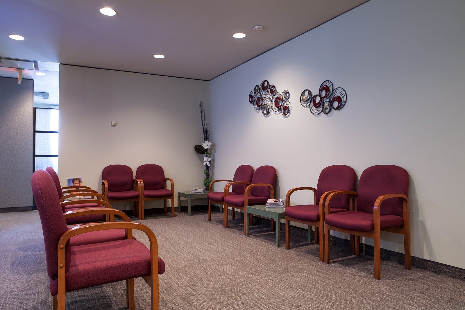 waiting room with multiple burgundy chairs