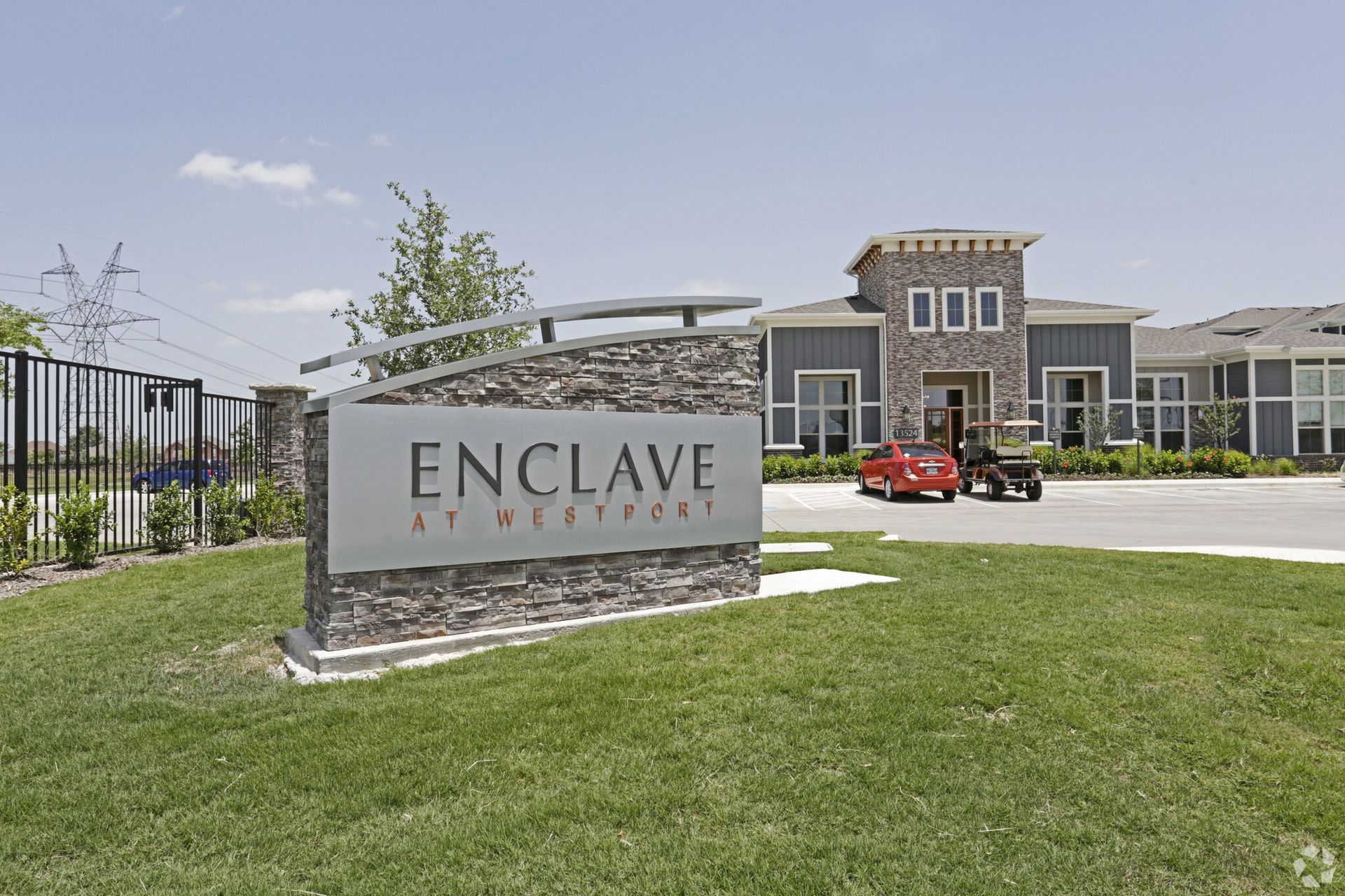 Entrance sign reading Enclave at Westport with building in background.