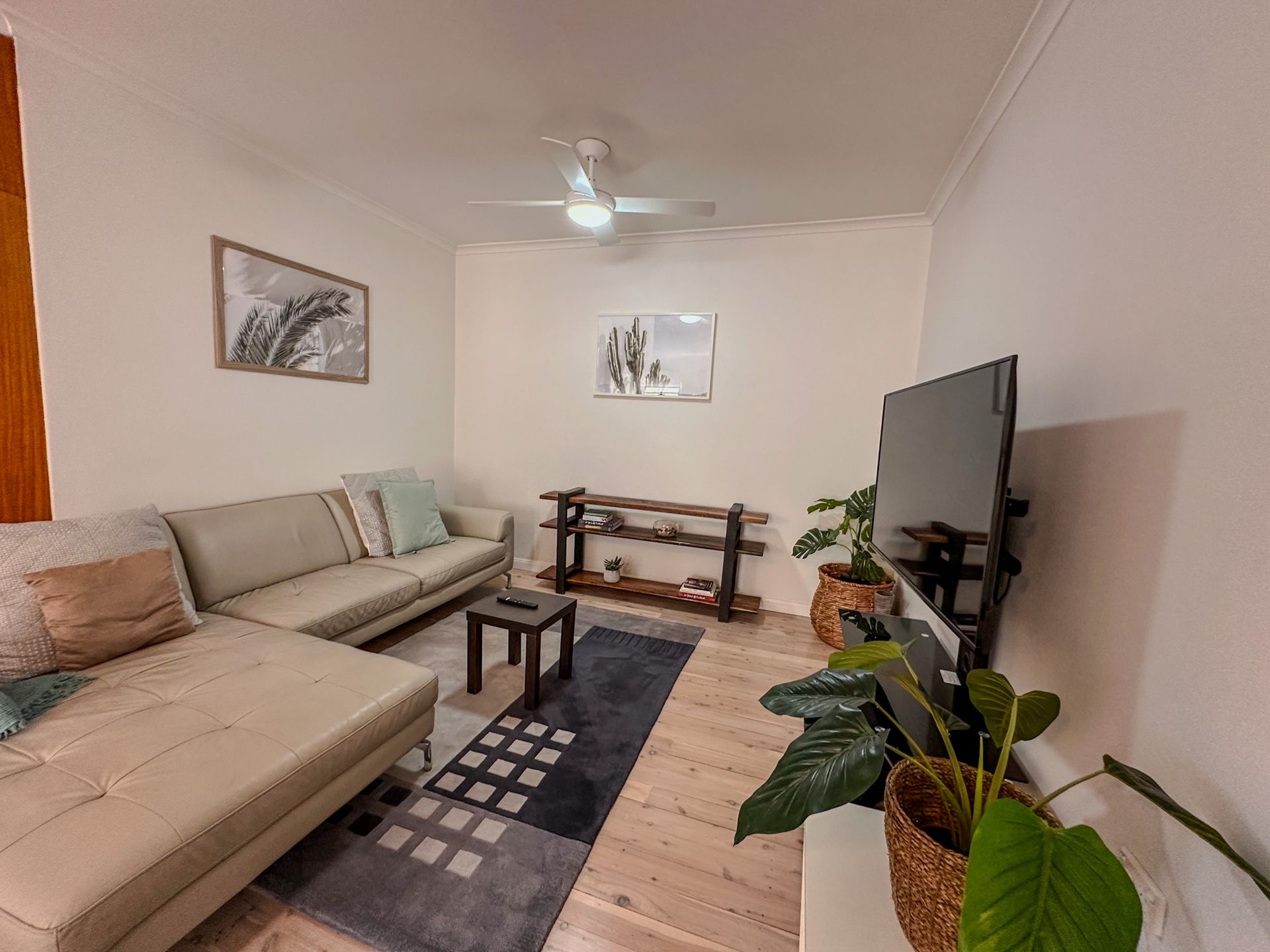 A living room with a couch and a flat screen tv.