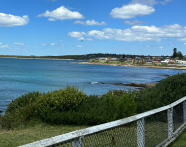 A view of a body of water with a fence in the foreground