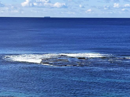 A large body of water with a boat in the distance.