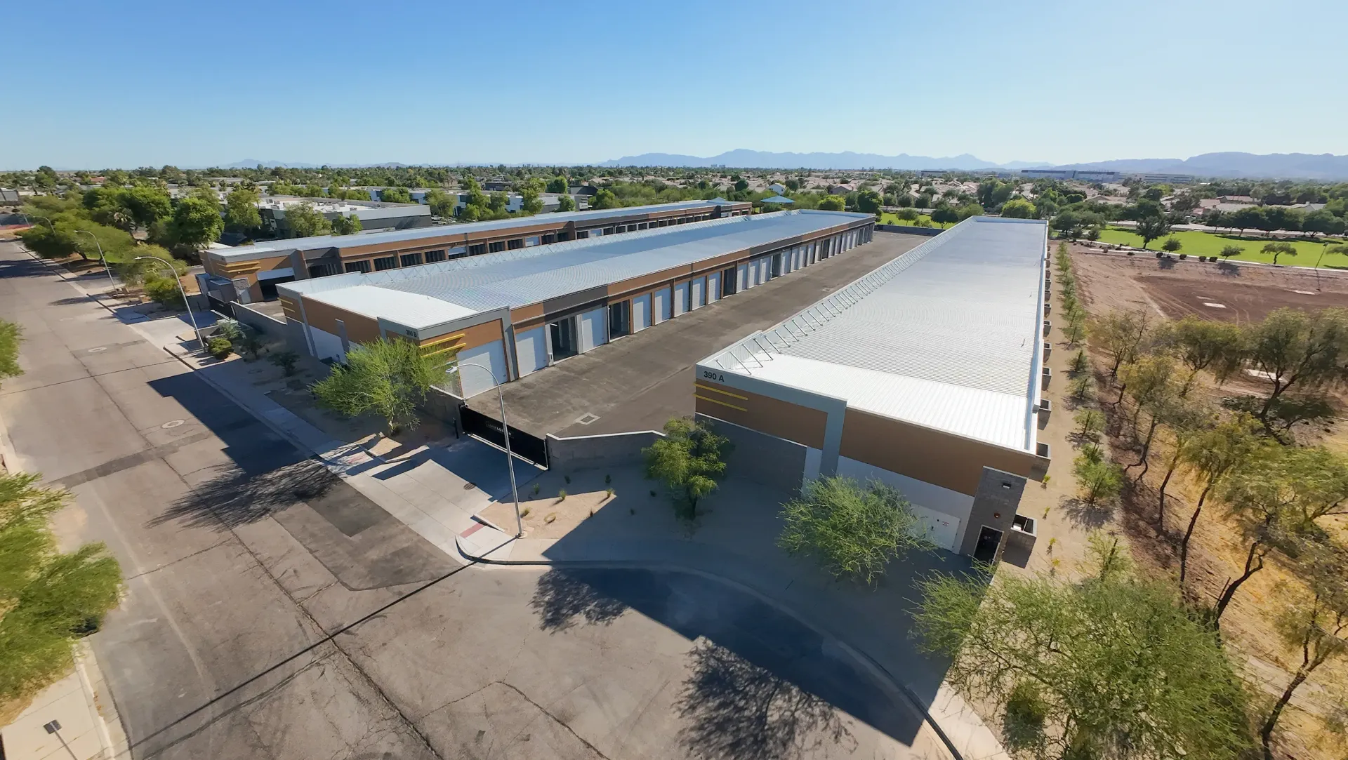 An aerial view of a large building with a white roof