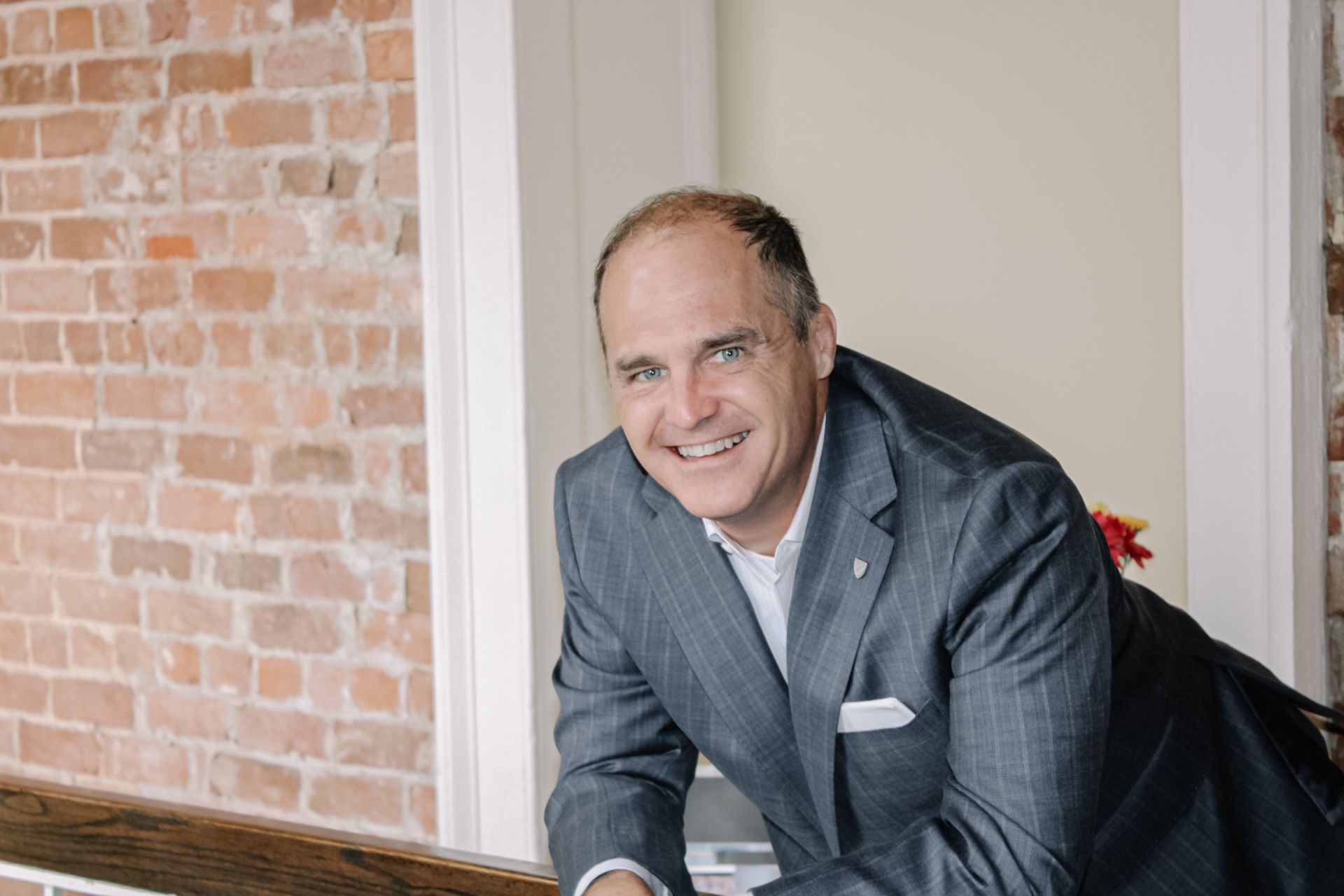 A black and white photo of a man in a suit and tie.
