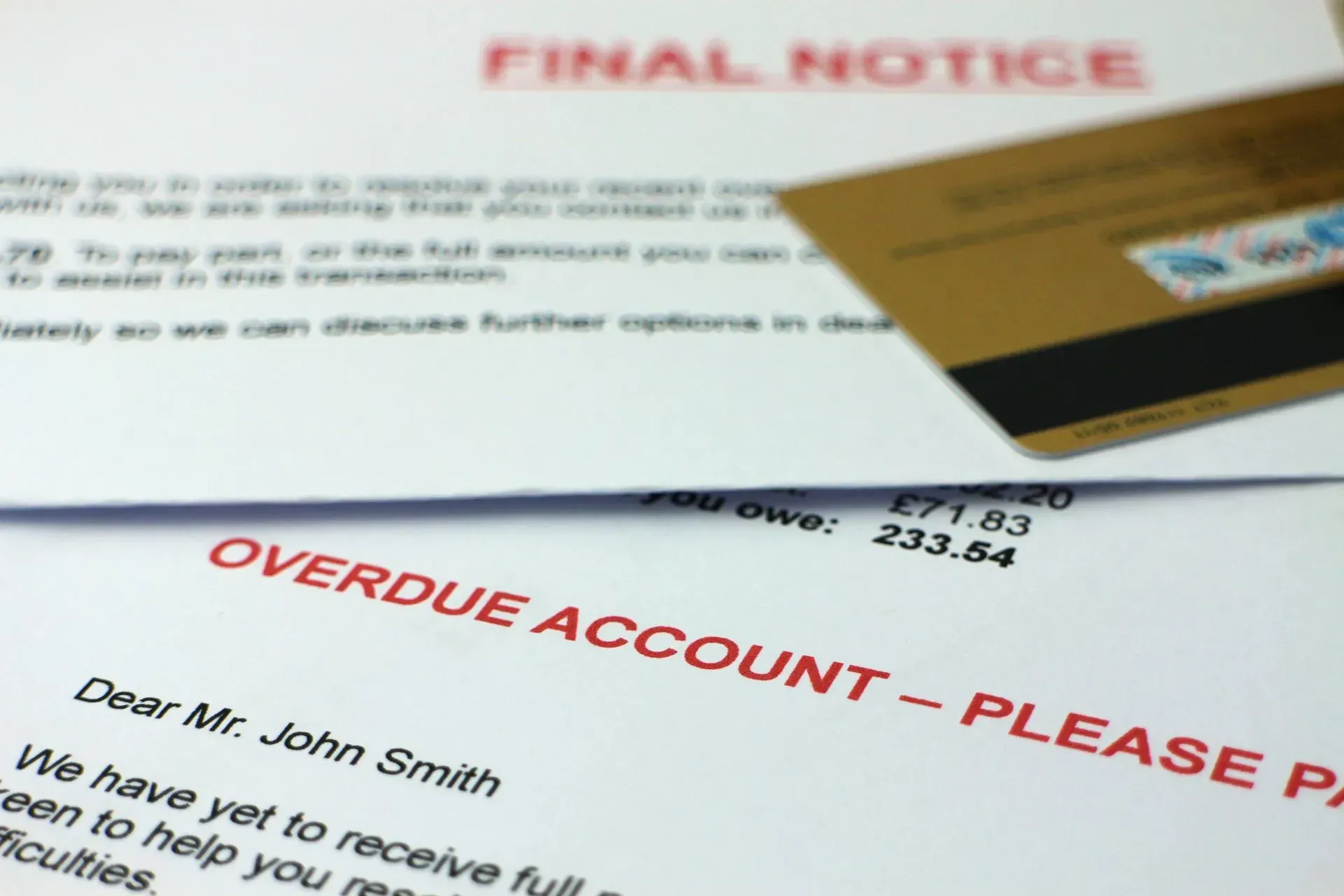 Overdue account notices and a credit card, including a final notice letter with red warning text