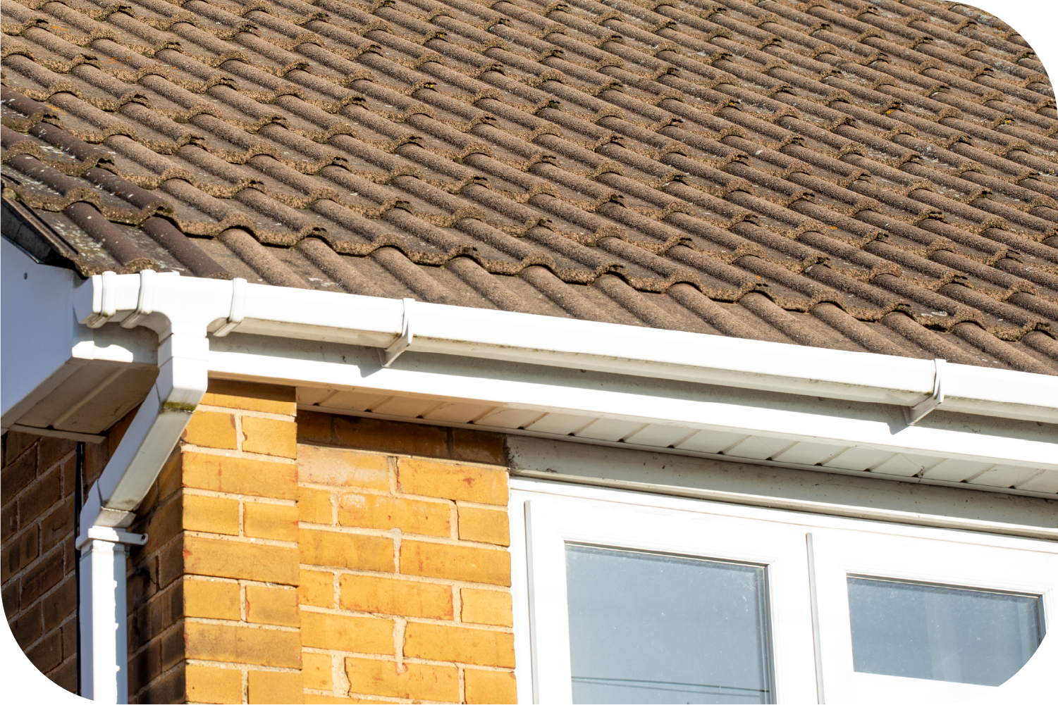A house with a brown roof and a white gutter
