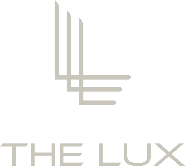 Logo for "The Lux" with stylized gray "L" characters.