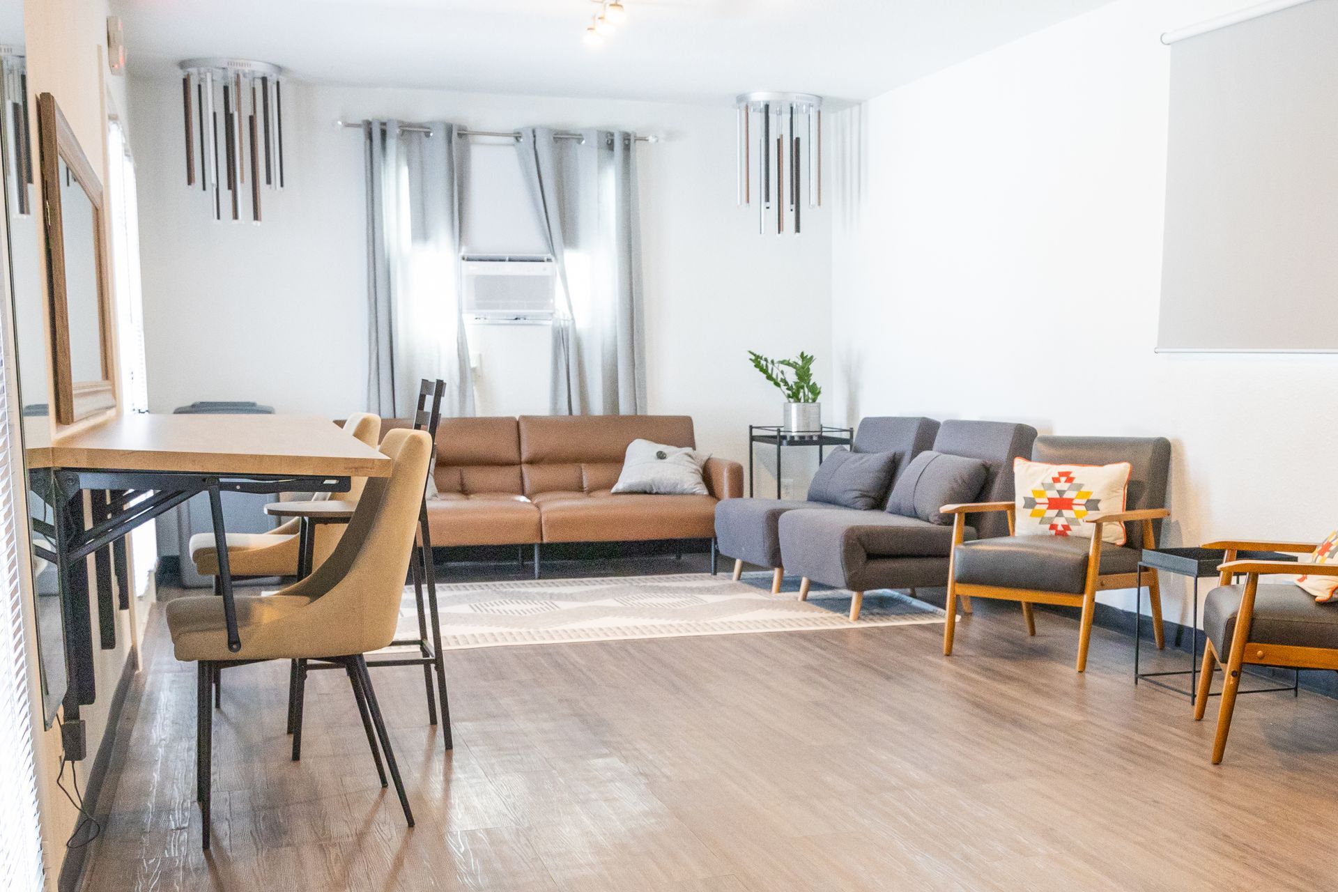 Comfortable additional room at MAHA ATX in Austin with three couches and a carpet on the floor