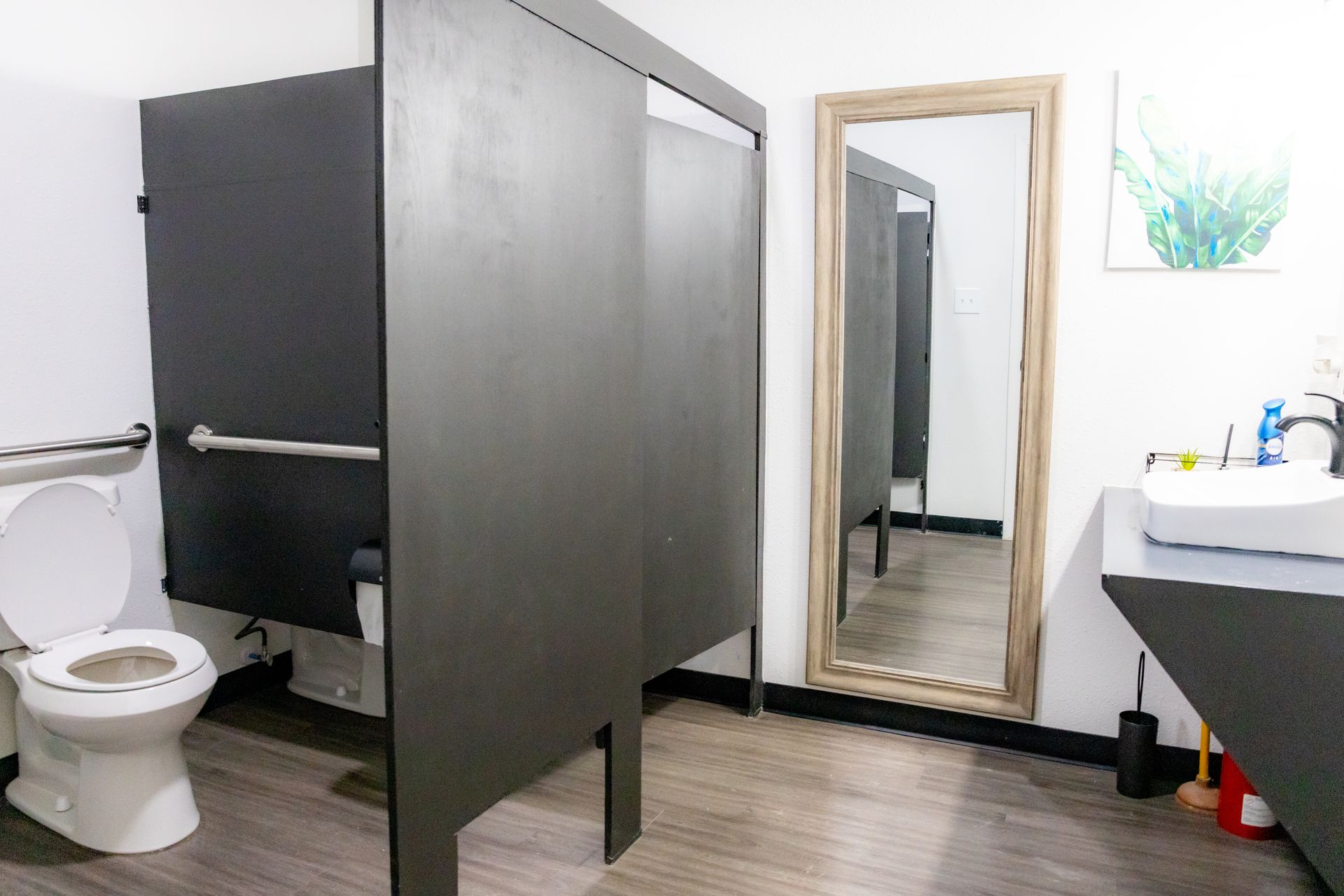 Austin's MAHA ATX bathroom with modern amenities including a toilet, sink, and shower stall