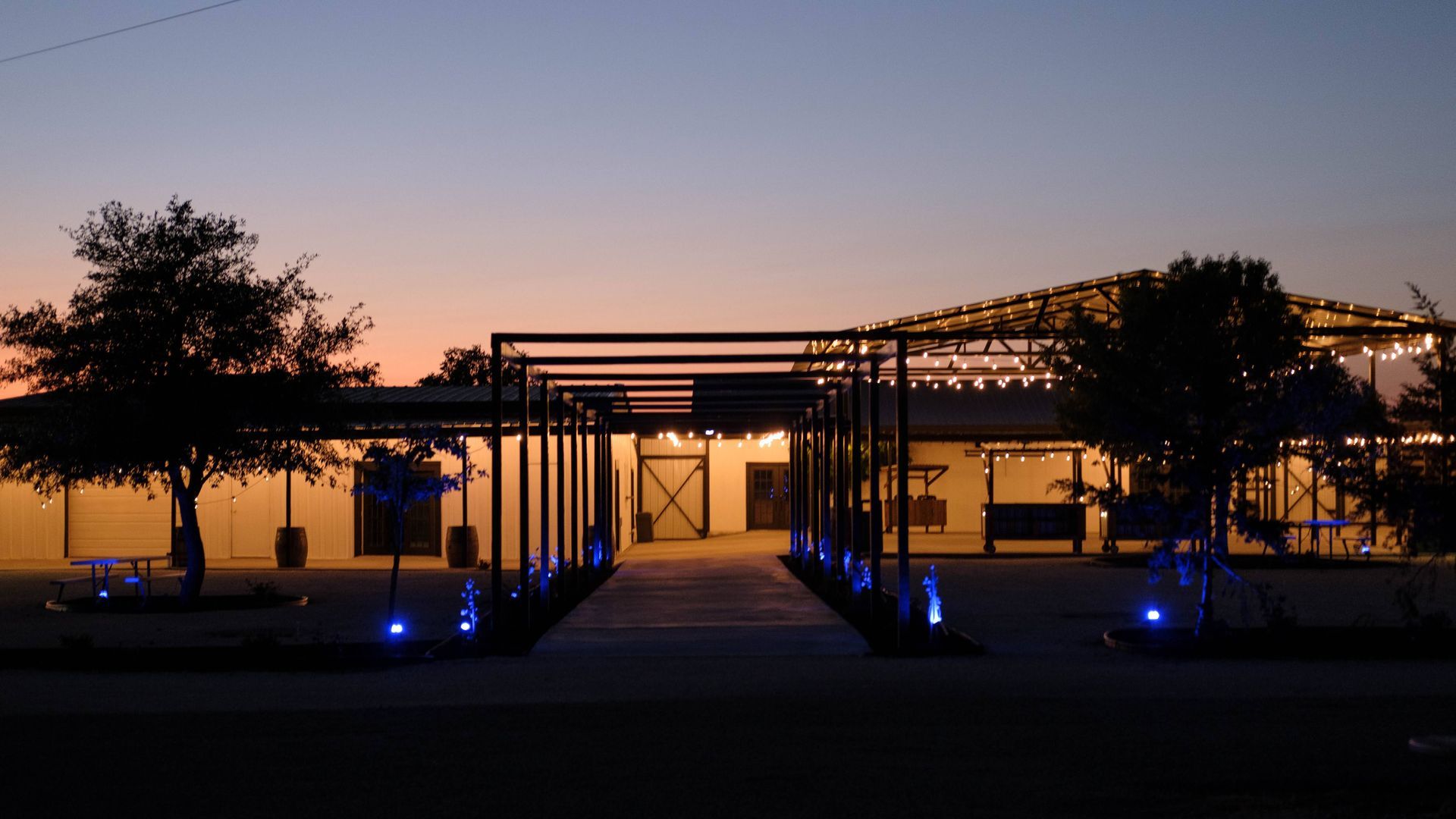 A wedding venue in Austin, Texas lit up at night with blue lights