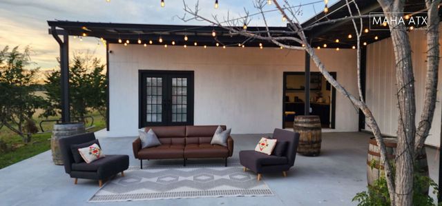 MAHA ATX patio with a couch and chairs 
