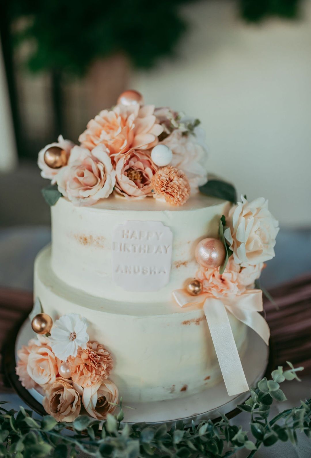 A wedding cake with flowers on top of it