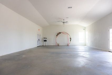 Empty indoor event venue with a ceiling fan in Austin, Texas