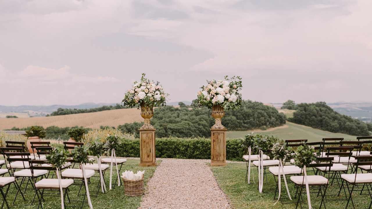 Scenic wedding venue with rolling hills, vineyards, and rustic charm.