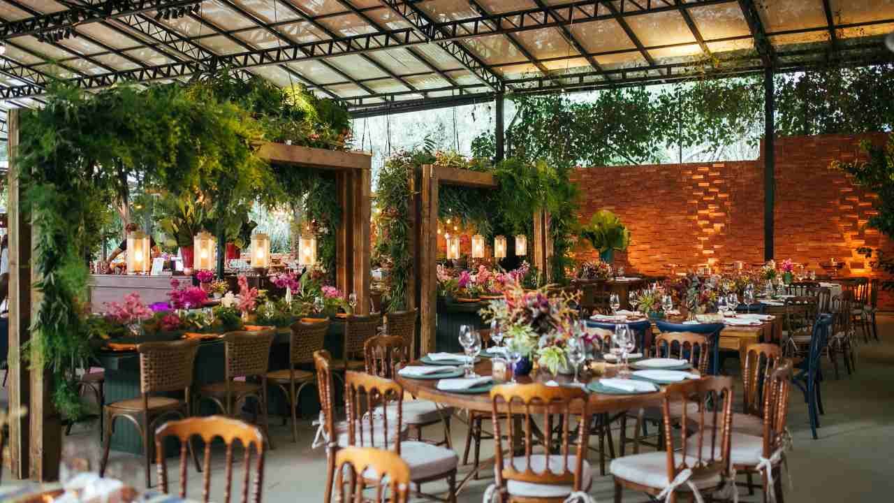 A large room with tables and chairs set up for a wedding reception.