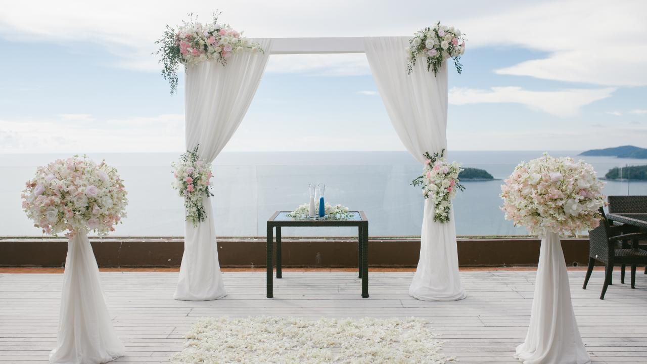 Wedding venue on terrace overlooking ocean.