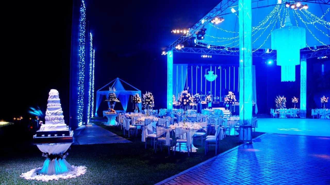 A beautifully decorated wedding reception featuring blue and white lights.