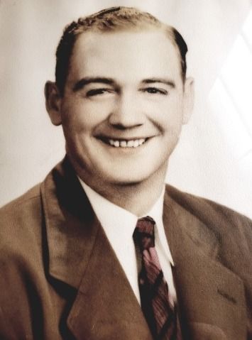 Man in suit smiles. Portrait in sepia tones.