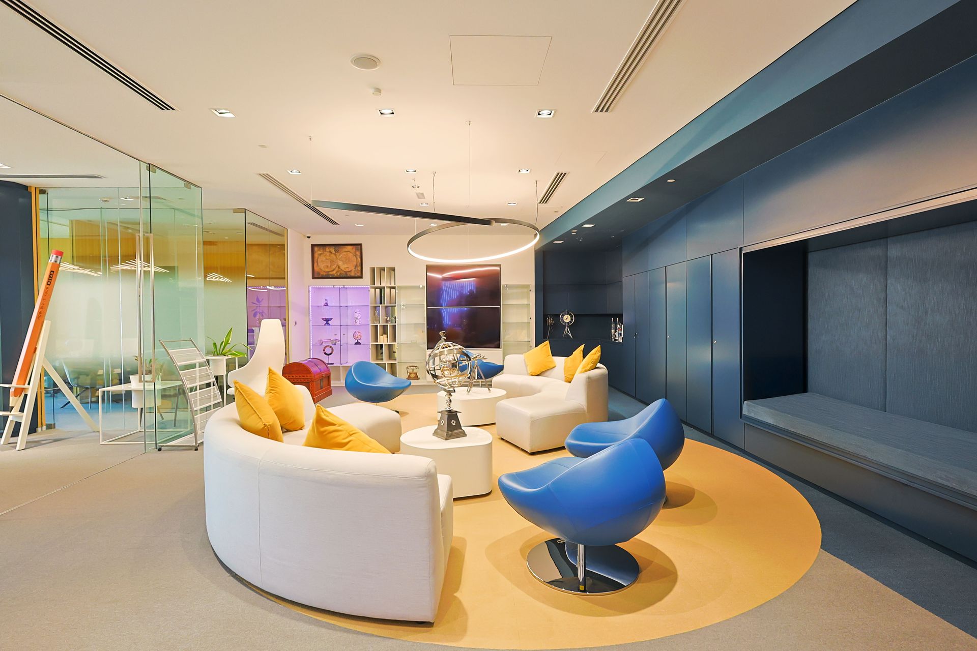 A living room with a white couch and blue chairs