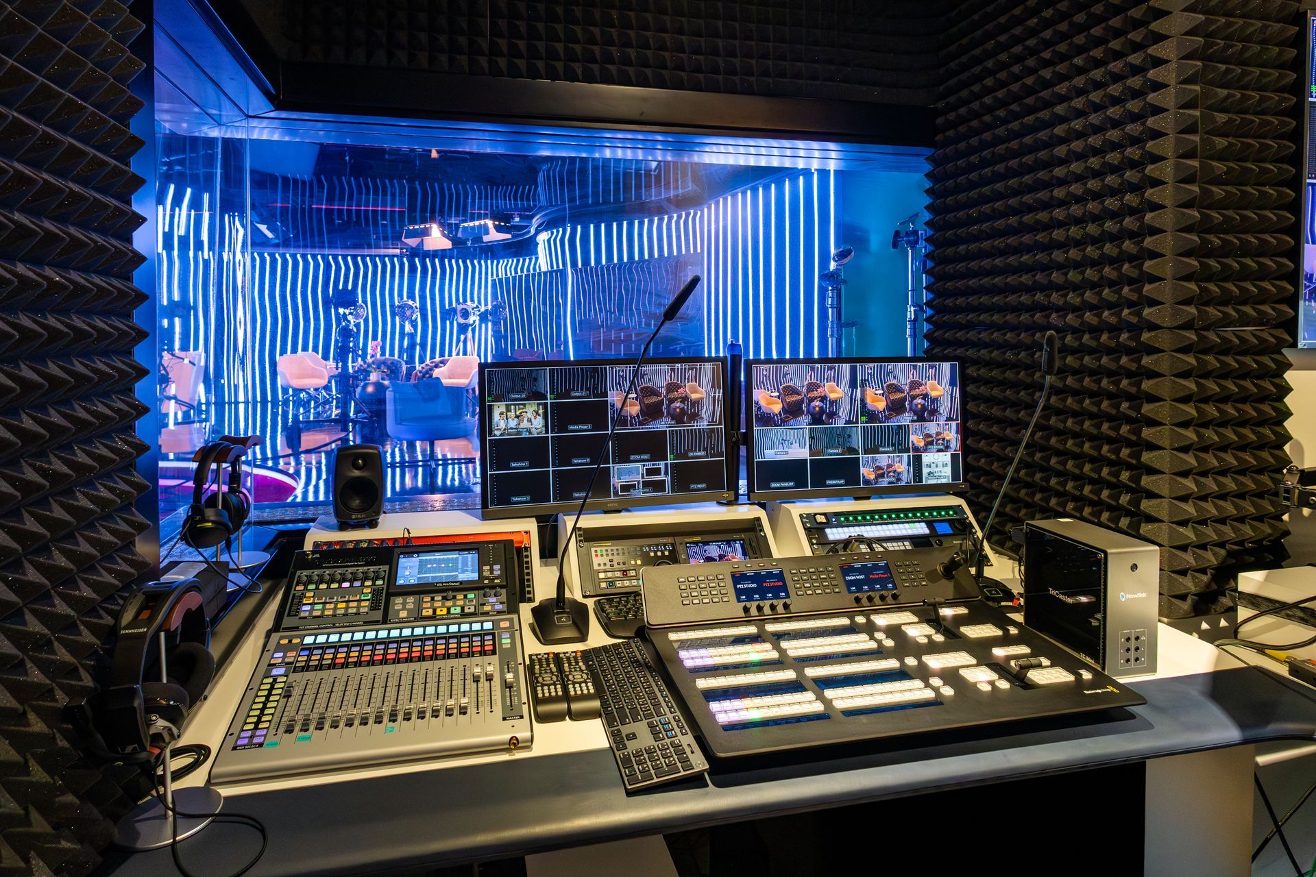 A recording studio with a lot of equipment on a table.