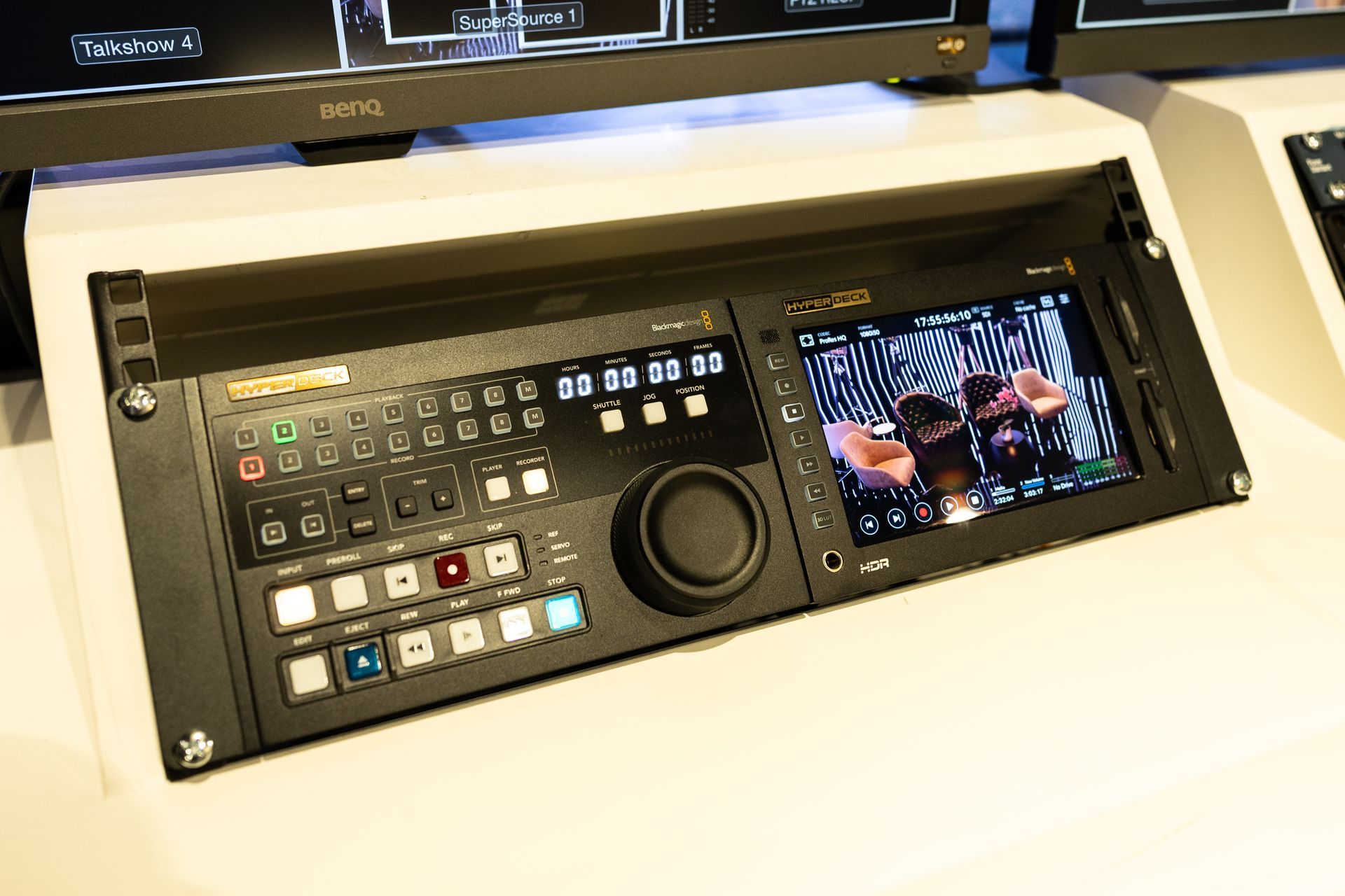 A video recorder is sitting on top of a white table.