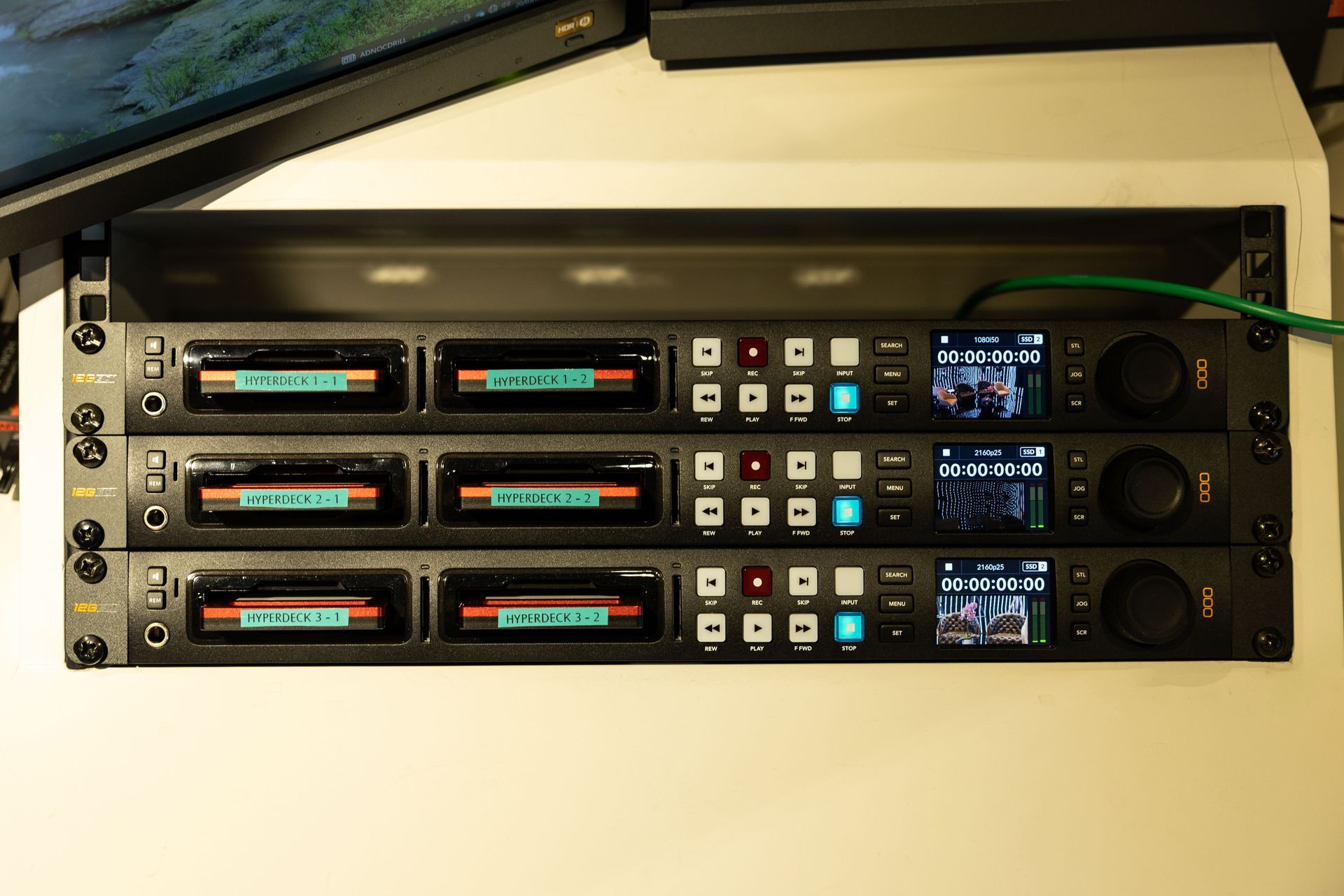 A bunch of electronic devices are stacked on top of each other on a table.