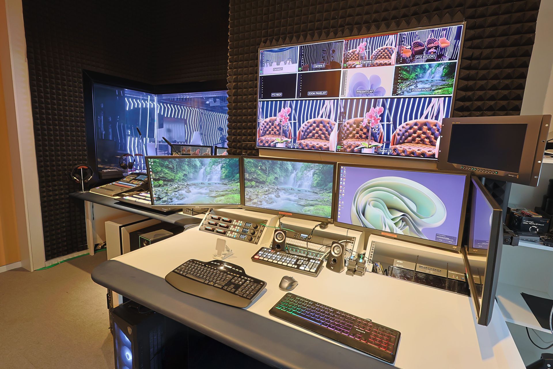 A computer desk with multiple monitors and a keyboard