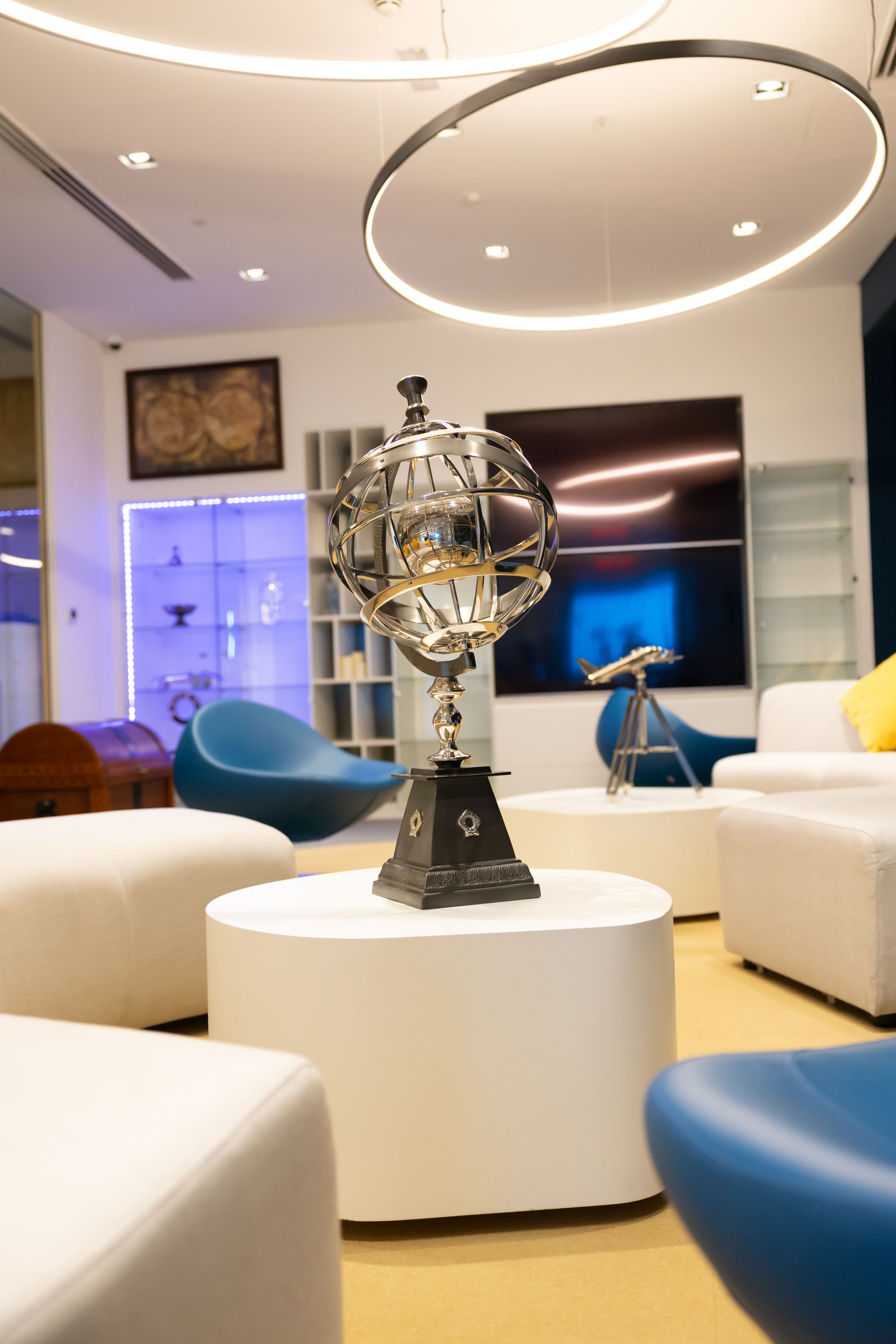 A wooden and brass telephone is sitting on a white table.