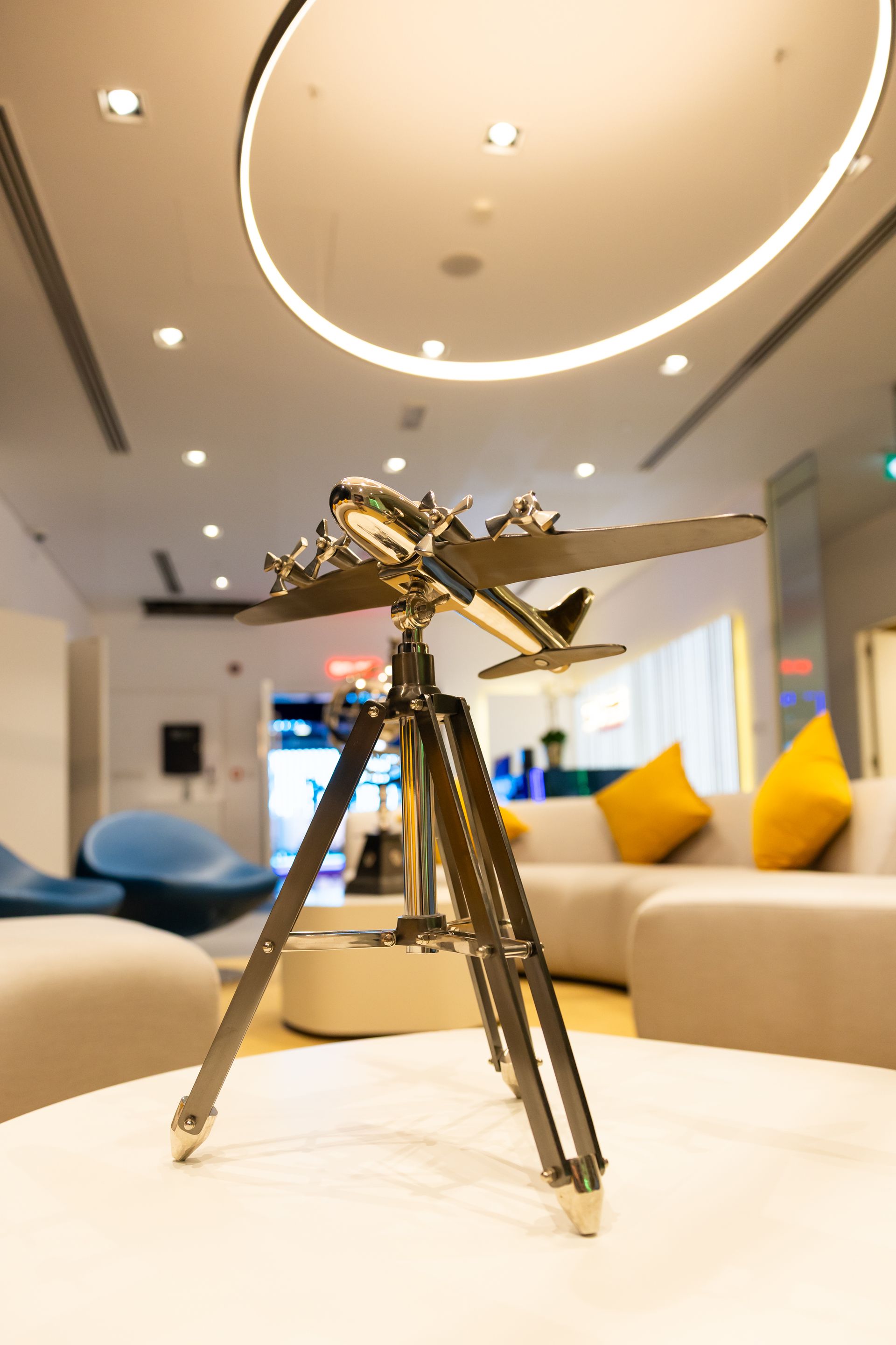 A wooden and brass telephone is sitting on a white table.