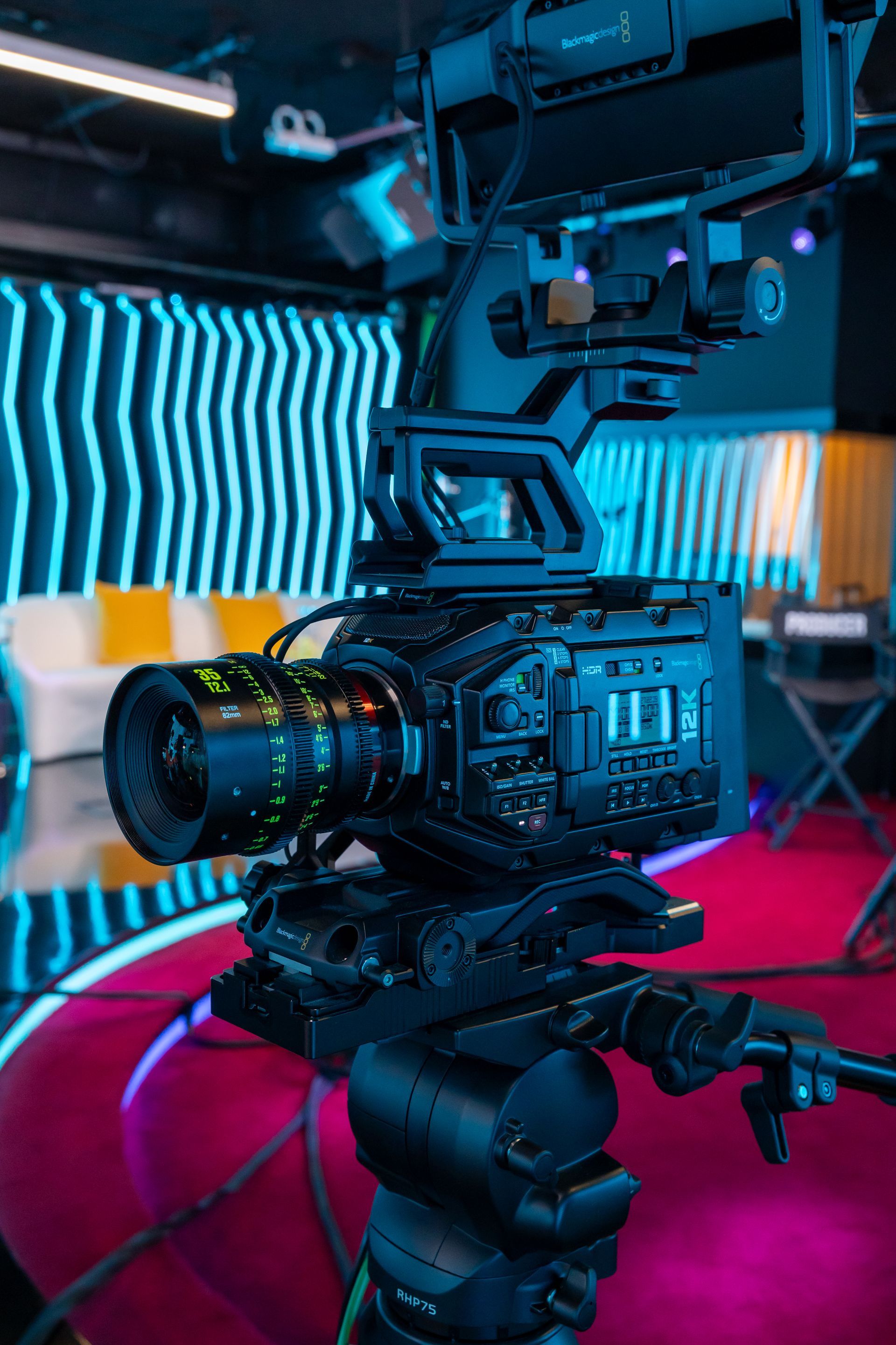 A camera is sitting on top of a tripod in a studio.