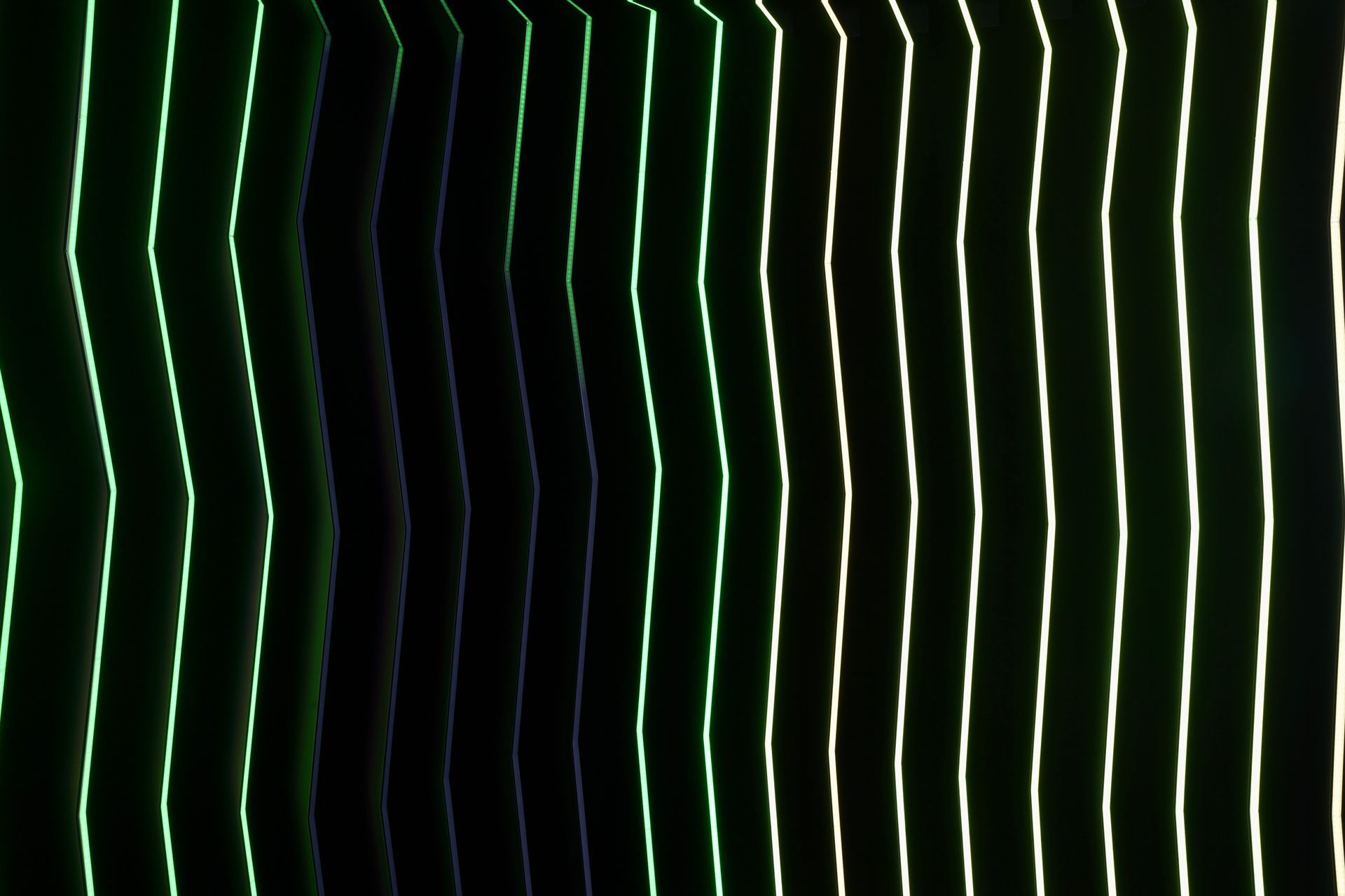 A row of green and white lines on a black background.