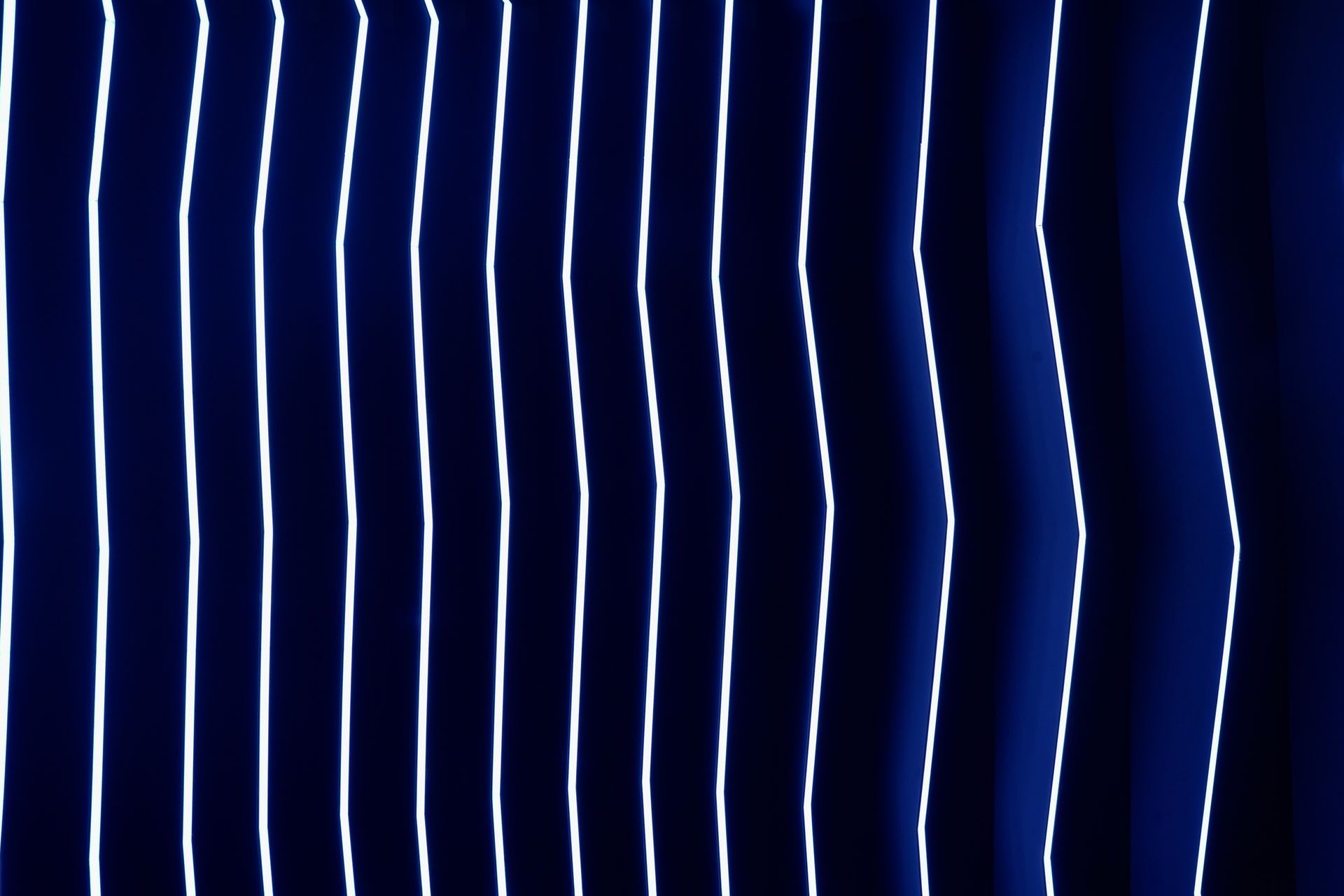 A close up of a blue curtain with white stripes on it.
