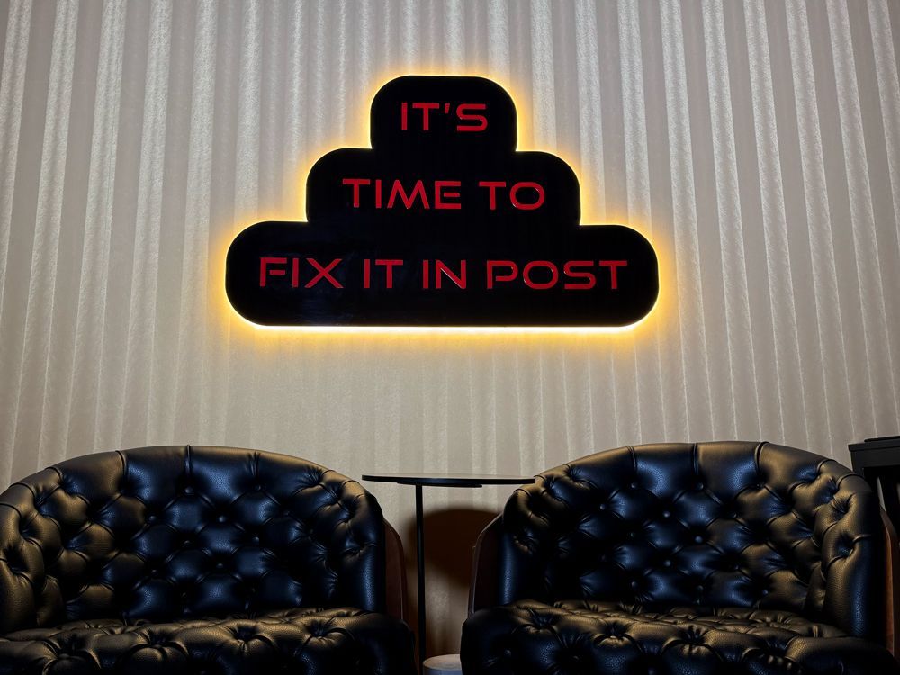 Two chairs in front of a sign that says it 's time to fix it in post