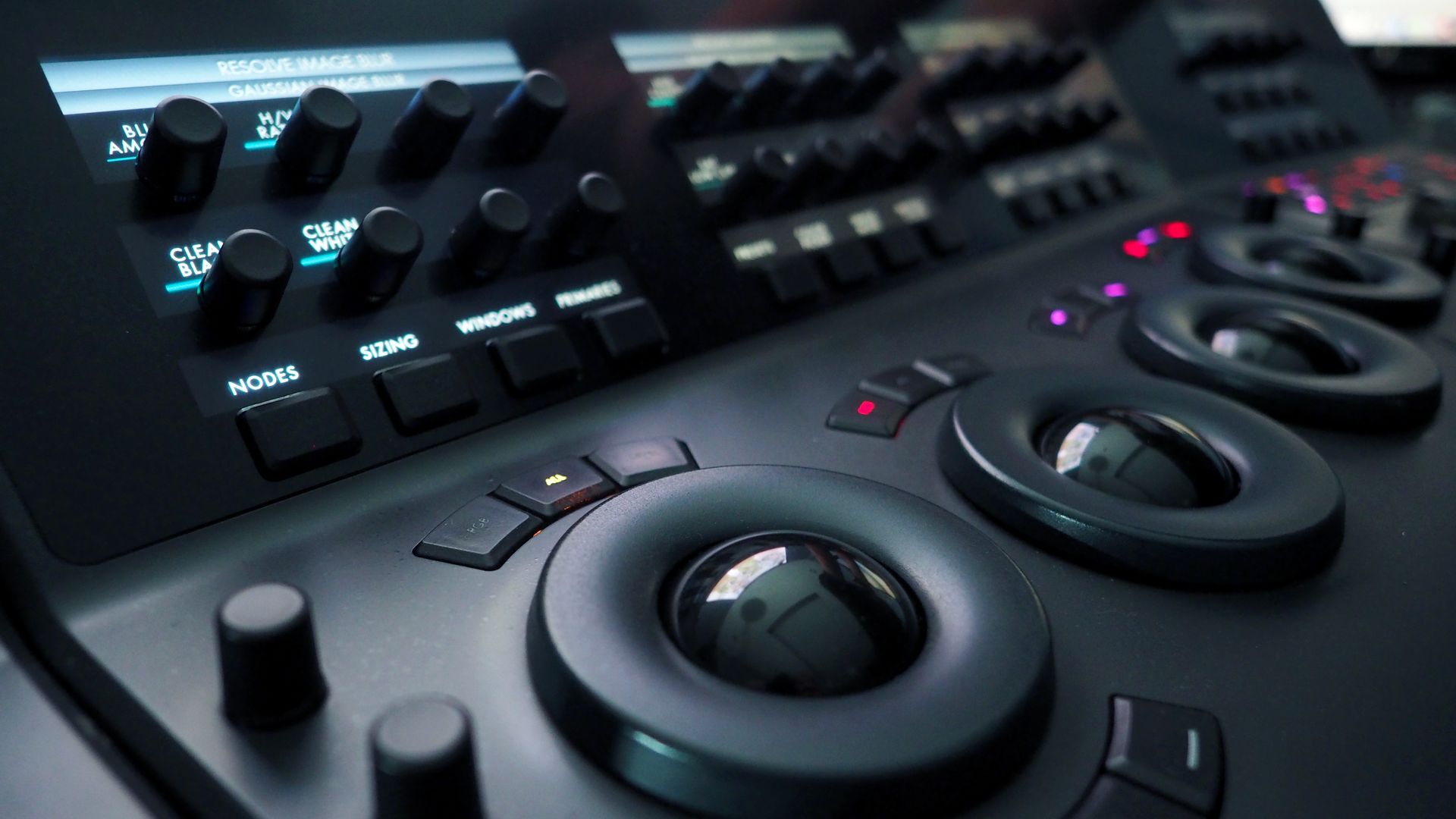 A close up of a control panel with a lot of buttons and knobs.