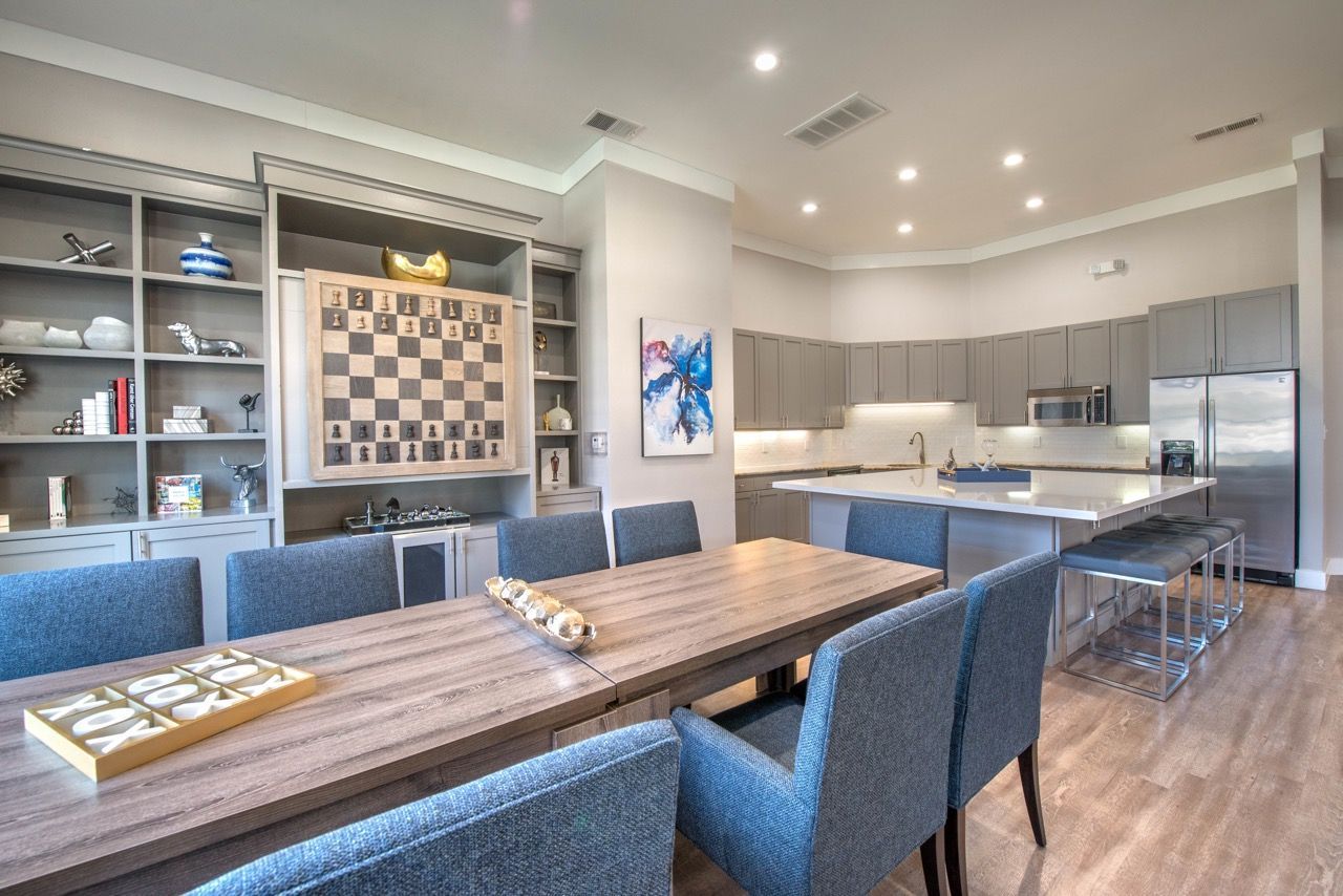 Open-concept communal kitchen and dining area with island and shelves.