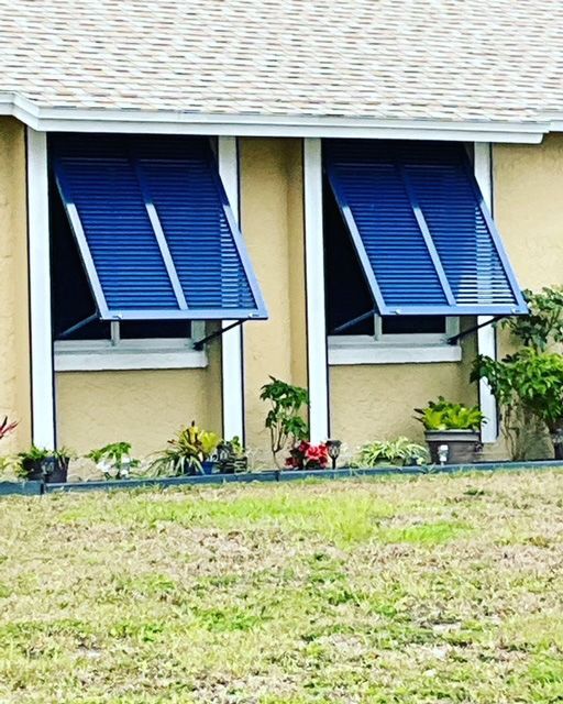 A house with blue shutters on the windows