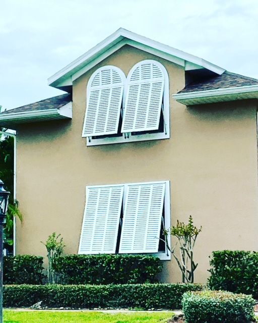 A house with two arched windows and white shutters